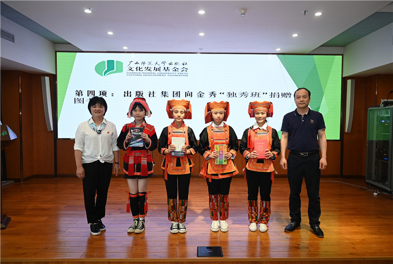 廣西師范大學(xué)出版社集團副總裁、工會(huì )主席莫曲波（右一）代表出版社向金秀“獨秀班”同學(xué)贈送圖書(shū)（李顯楊攝）.jpg